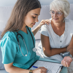 home health nurse checking blood pressure of her patient